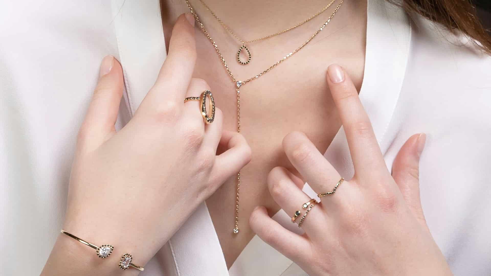 Layered jewellery worn with a white blouse in our Dubai fashion and jewellery guide